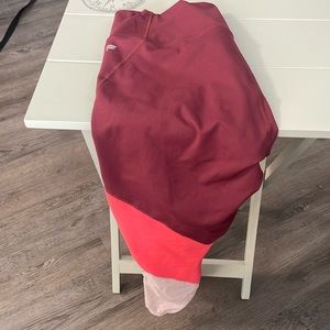 Fabletics leggings size 10 burgundy, salmon, cream color.